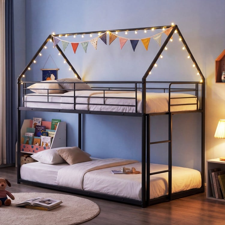 House-shaped twin over twin metal bunk bed in black with roof, ladder, and decorative lights for kids' rooms.