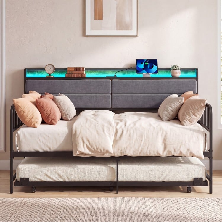 Twin size daybed with trundle and upholstered headboard, featuring RGB LED lights for a cozy atmosphere.