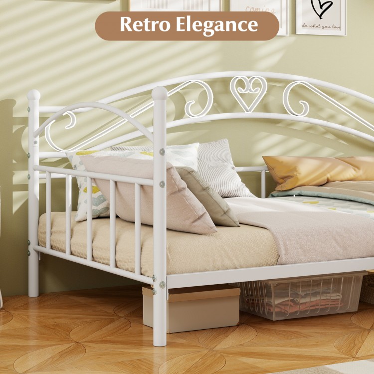 Twin size white metal daybed frame with heart-shaped decoration, featuring cozy cushions and ample under-bed storage.