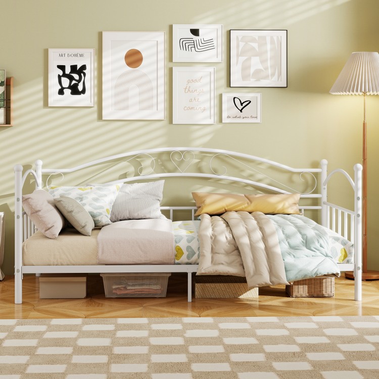 Twin size metal daybed frame in white with heart-shaped design, featuring cozy bedding and ample under-bed storage.