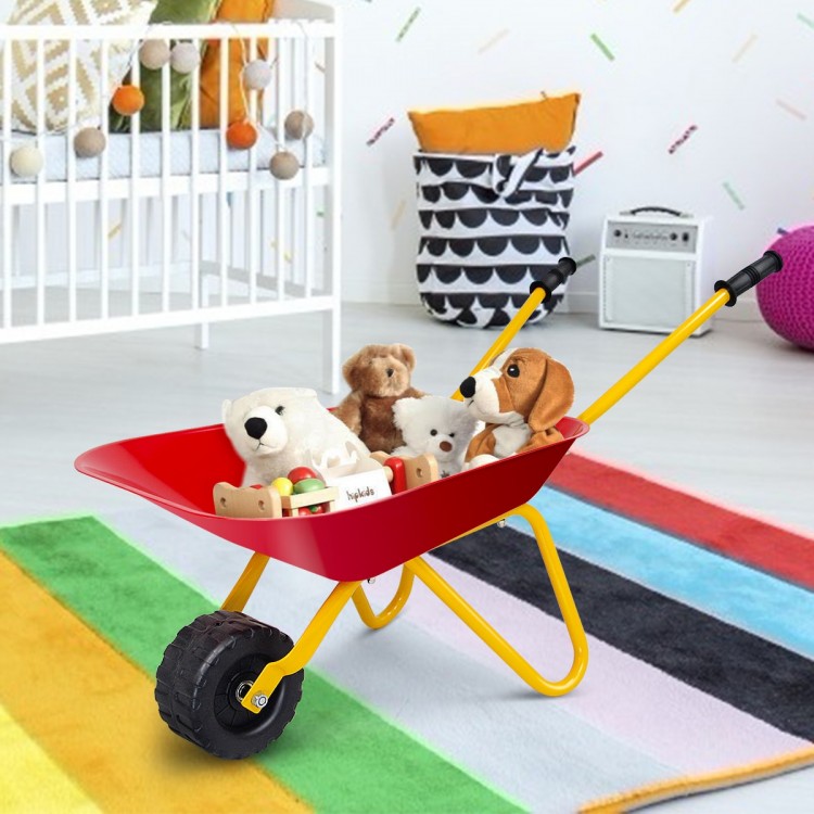 Red metal wheelbarrow for kids filled with plush toys, perfect for yard play and transporting treasures.