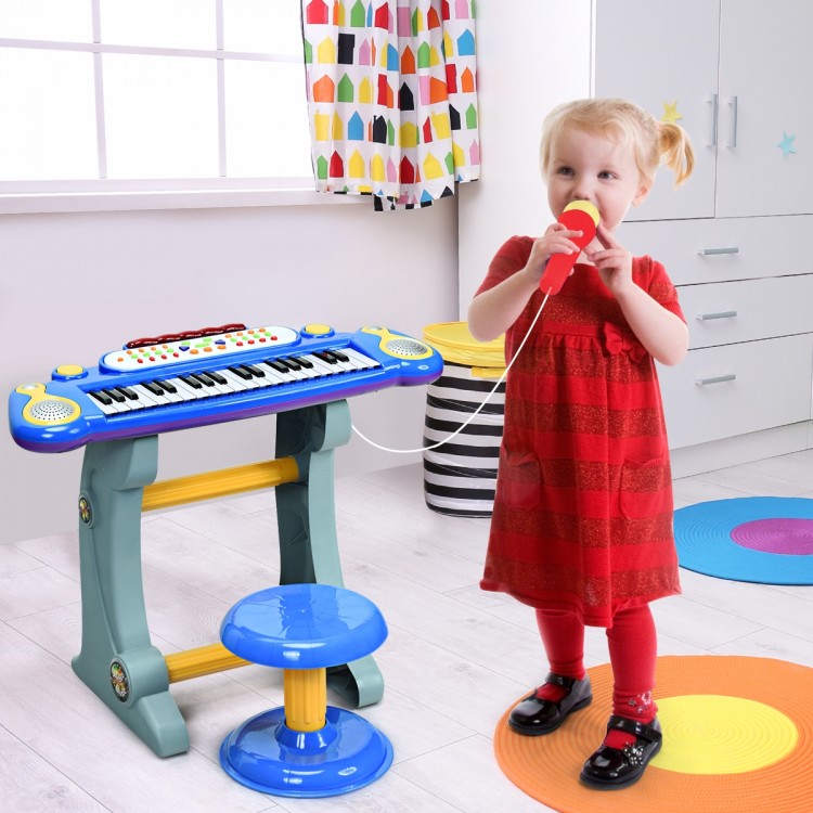 Child playing with a blue 37 key electronic keyboard piano, featuring a detachable microphone and stool for interactive.