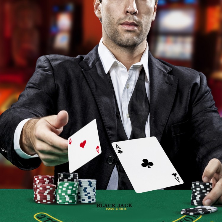 Close-up of a player holding two cards in a casino setting, featuring a 300-piece poker chip set for card games.