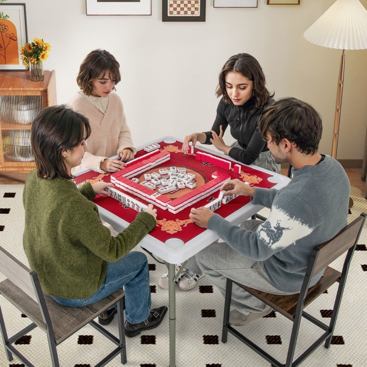 Four players enjoy a game on the 35-inch red folding mahjong table with cup holders, featuring a smooth felt surface.