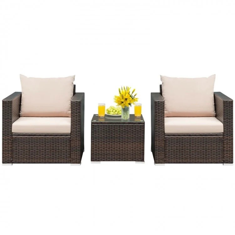 Two patio chairs with cream cushions and a coffee table, part of a 6-piece rattan furniture set for outdoor relaxation.