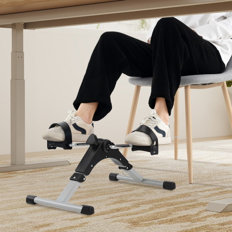 Under desk exercise bike pedal exerciser in black, featuring adjustable resistance and LCD display for leg and arm.