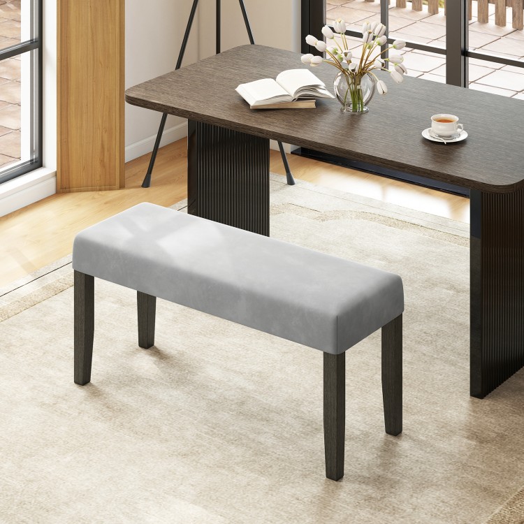 Gray padded end of bed bench with solid wood legs, perfect for bedroom or entryway seating and storage.