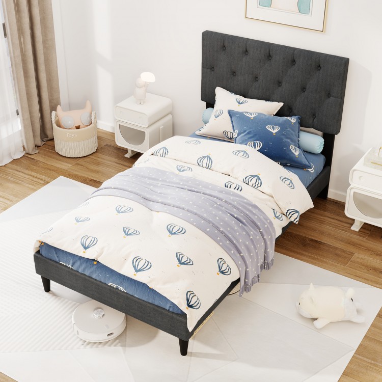 Twin size upholstered platform bed in gray with tufted headboard, featuring a padded surface and wooden slats for.