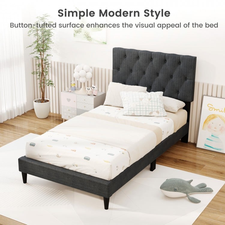 Upholstered twin size platform bed in gray with tufted headboard, featuring a padded surface and wooden slats for.