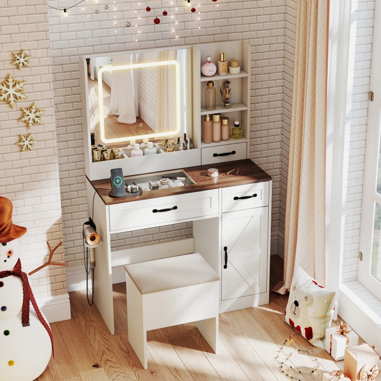 Vanity desk with lighted mirror, ample storage, and a stool, designed in a farmhouse style for makeup application.