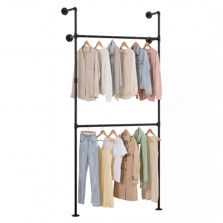 Wall-mounted black clothing rack with two hanging rods, featuring coats and dresses for organized storage in any space.