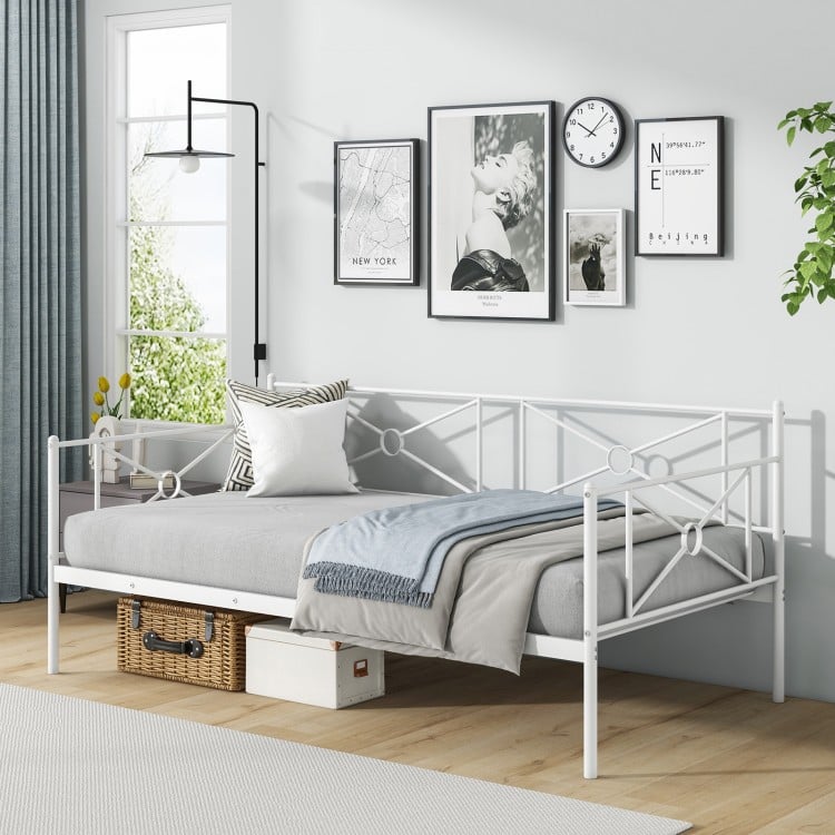 White metal twin daybed with chic side rails, suitable for bedroom or living room, featuring under-bed storage.