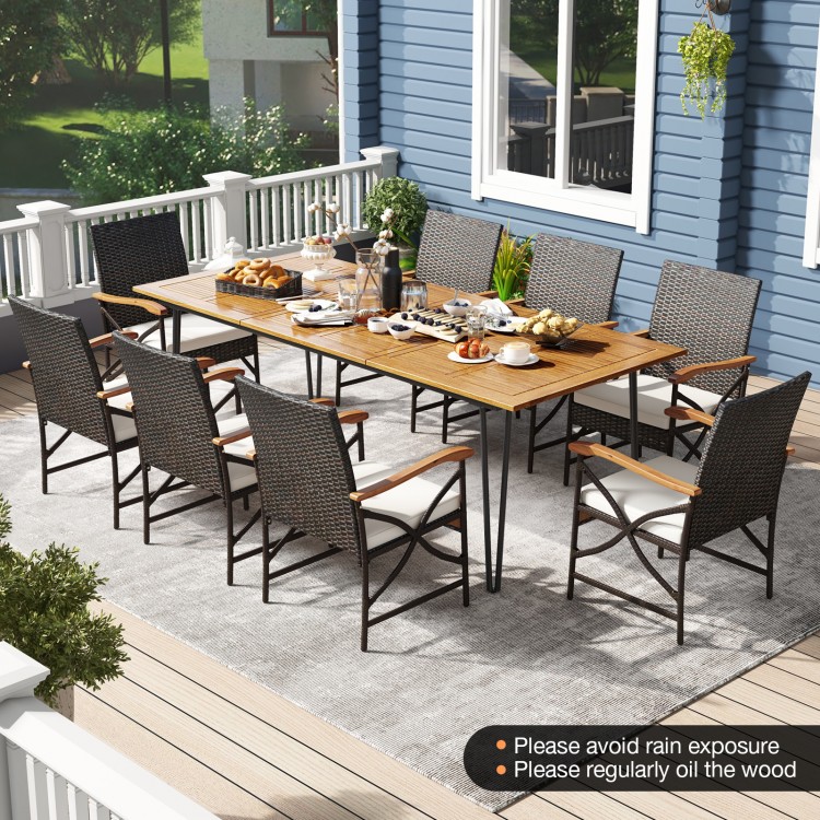Wicker patio furniture set featuring 8 armchairs with cushions and an acacia wood square table for outdoor dining.