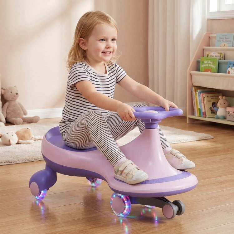 Child happily using the purple Wiggle Car Ride-on Toy with flashing wheels on a wooden floor, ideal for active play.