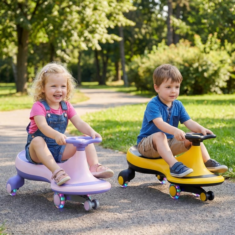 Two children riding the Wiggle Car Ride-on Toy in yellow and purple, featuring flashing wheels for outdoor fun.