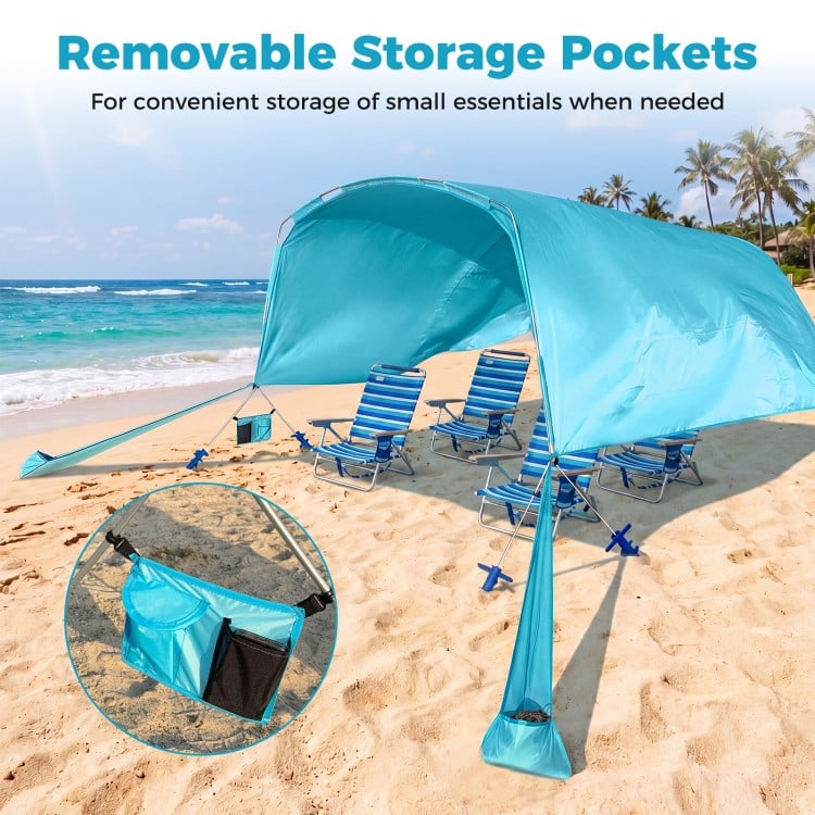 Portable blue beach tent with removable storage pockets, accommodating 6-8 people for sun protection during picnics.