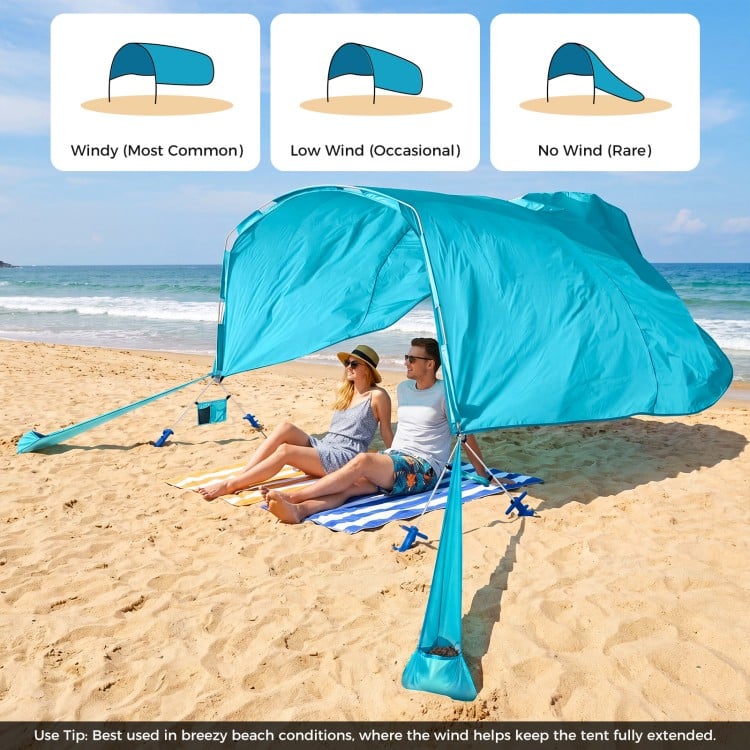 Portable blue beach tent providing 137 sq.ft shade for 6-8 people, ideal for picnics and gatherings by the sea.