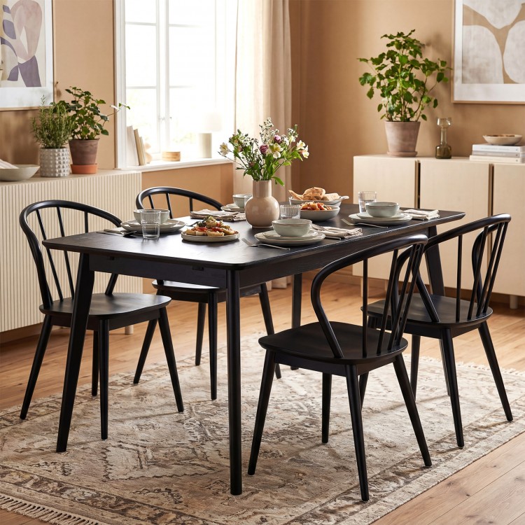 Black Windsor dining chairs set of 4 featuring a spindle backrest, concave seat, and rubber wood for stability.