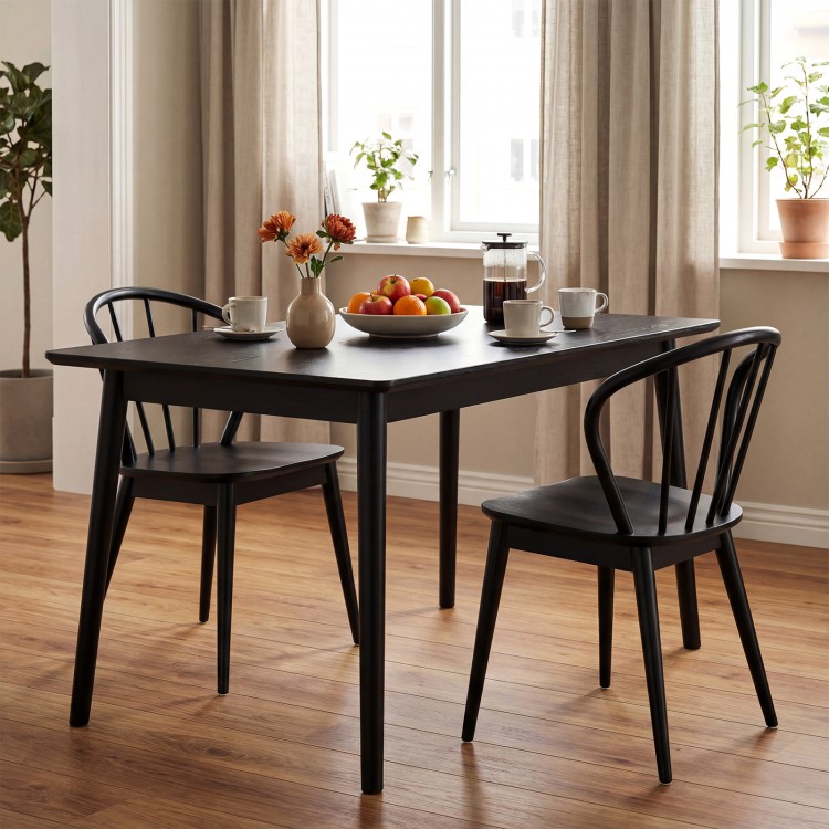 Black Windsor dining chairs with spindle backrest around a dining table, featuring a retro design for elegant home.
