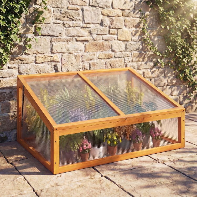 Wood cold frame greenhouse with transparent flip-top roof, featuring fir wood construction for plant protection.