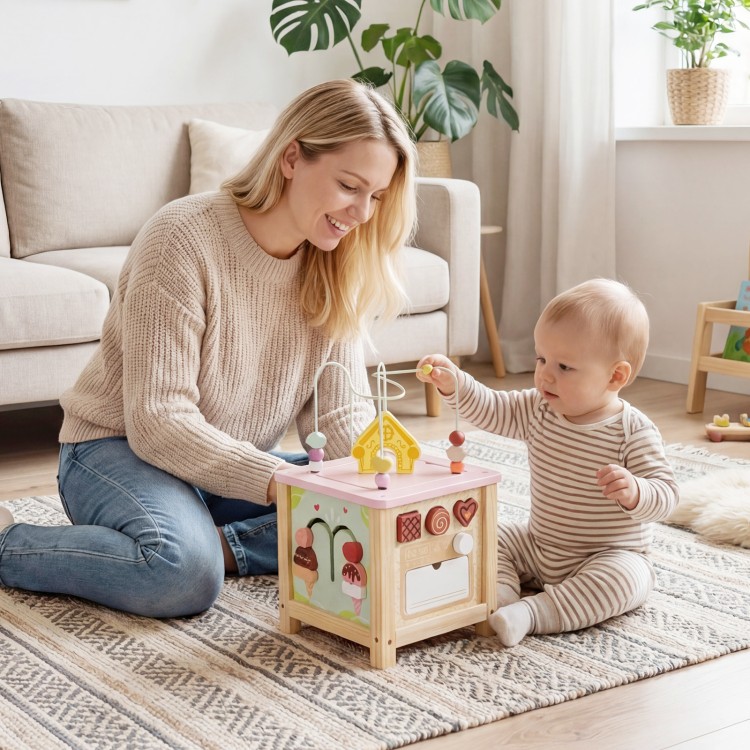 Wooden activity cube with sensory toys, featuring shape matching blocks and a pretend kitchen for toddlers 18+ months.