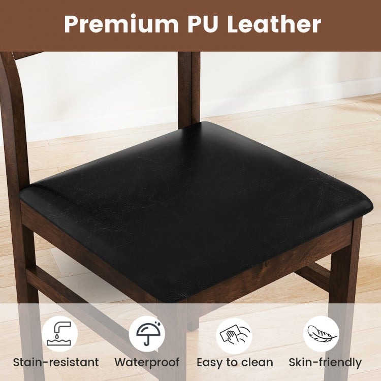 Close-up of a black PU leather padded seat on a wooden dining chair, featuring a walnut rubber wood frame for.