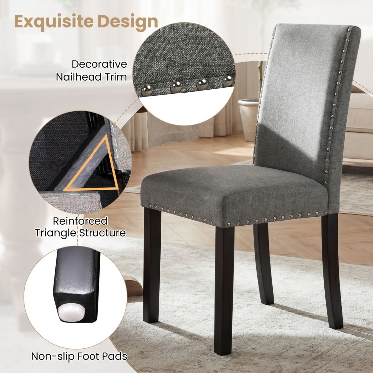 Gray wooden dining chair with decorative nailhead trim and non-slip foot pads, ideal for home or cafe settings.