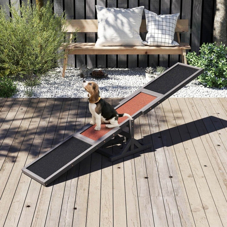 Wooden dog agility seesaw in gray with textured surfaces, perfect for outdoor training and exercise for dogs.