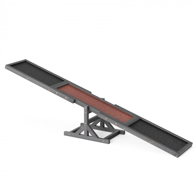 Wooden dog agility seesaw in gray with a sand grain asphalt surface, designed for outdoor obstacle courses and training.
