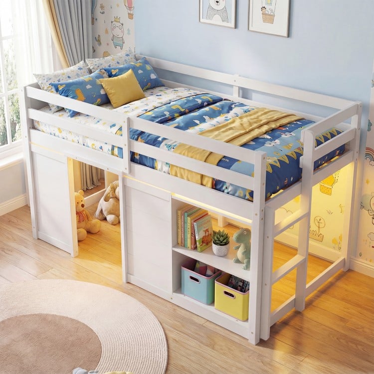 Wooden low kids loft bed in white with LED lights, spacious under-bed area, and ample storage for toys and books.