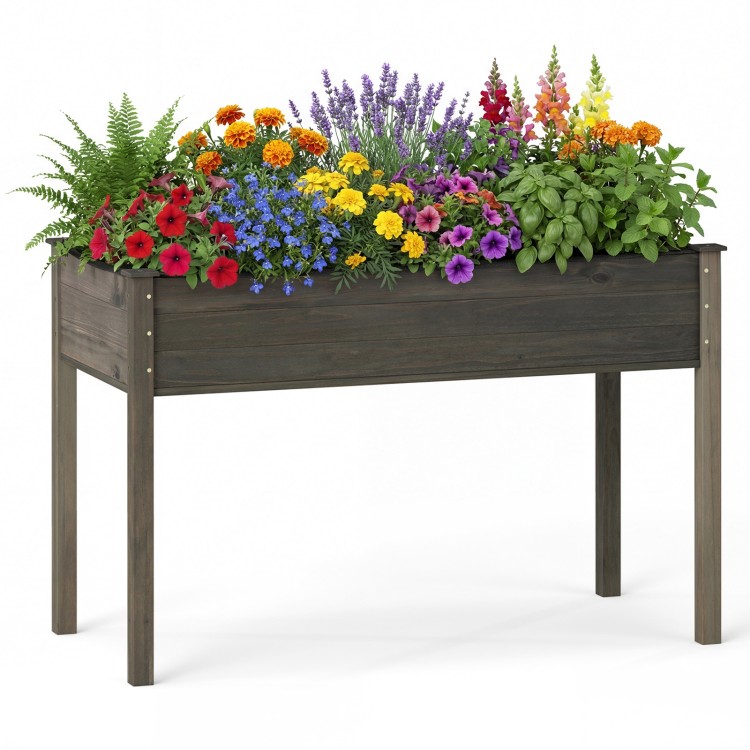 Elevated wooden vegetable garden bed in gray filled with colorful flowers, ideal for backyard or patio planting.