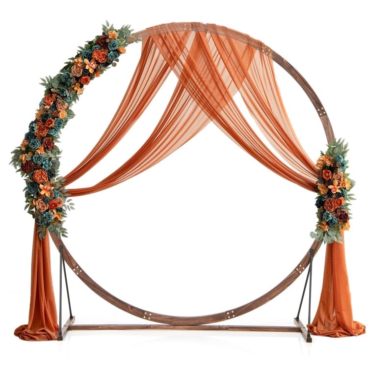 Wooden wedding arch with floral accents and draped fabric, ideal for ceremonies and outdoor events.