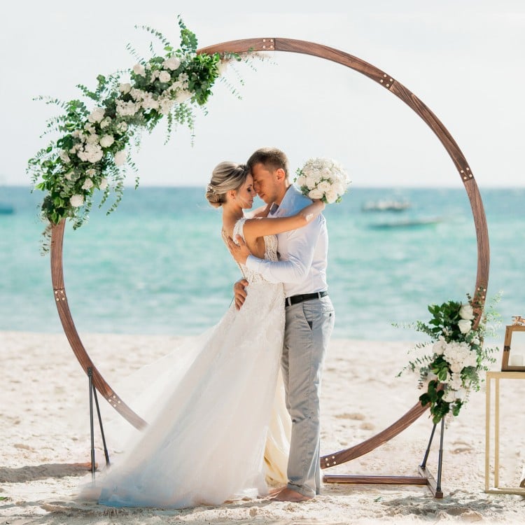 Wooden wedding arch made of natural fir wood, perfect for beach ceremonies and customizable with flowers and.