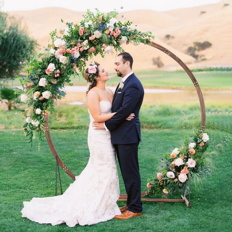 Wooden wedding arch made of natural fir wood, round shape, ideal for outdoor ceremonies and floral decorations.