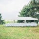 Large 10 x 30 feet canopy tent with removable sidewalls, ideal for outdoor parties and weddings, set on grassy ground.