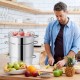11-quart stainless steel fruit juicer steamer with apples, ideal for making fresh juice and convenient for all cooktops.