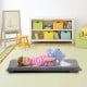 Adjustable gray floor chair in a living room setting, perfect for reading, gaming, or lounging comfortably.