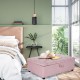 Folding ottoman sleeper bed in pink with thick mattress, ideal for guest use or office naps, placed in a stylish.