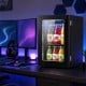 Beverage refrigerator with a sleek glass door showcasing colorful drinks, designed for efficient cooling and compact spaces.