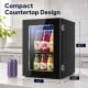 Compact 0.6 Cu.Ft black beverage refrigerator with a glass door, holding 24 cans for efficient cooling in any room.