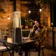 Portable steel tabletop patio heater with glass tube, 10000 BTU, providing 360° heat for outdoor gatherings.