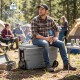 Portable wheeled ice cooler with a 330 lbs weight capacity, designed for camping and outdoor activities, featuring foldable handles.