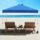 Blue 10 x 10 ft pop-up canopy tent with sidewall, set up on the beach with two lounge chairs for sun protection.