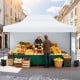 Pop up canopy tent in white, 10x14 ft, providing sunshade for outdoor markets with sidewalls and strong support.