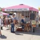 Foldable pink pop-up canopy with adjustable height, ideal for outdoor events, featuring a banner strip for promotions.