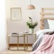 Compact nesting coffee tables with round white MDF tops and elegant gold frames, perfect for stylish and small spaces.