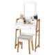 Vanity table set with cushioned stool, large mirror, and three storage drawers for cosmetics and accessories.