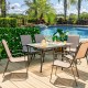 7-piece patio dining set featuring a rectangular glass table and 6 stackable chairs, perfect for outdoor gatherings.