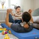 Self-inflating blue camping sleeping mattress with a child playing on it, ideal for outdoor use and travel.