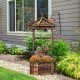 Rustic wooden wishing well planter with hexagonal roof, adjustable bucket, and climbing poles for versatile outdoor.